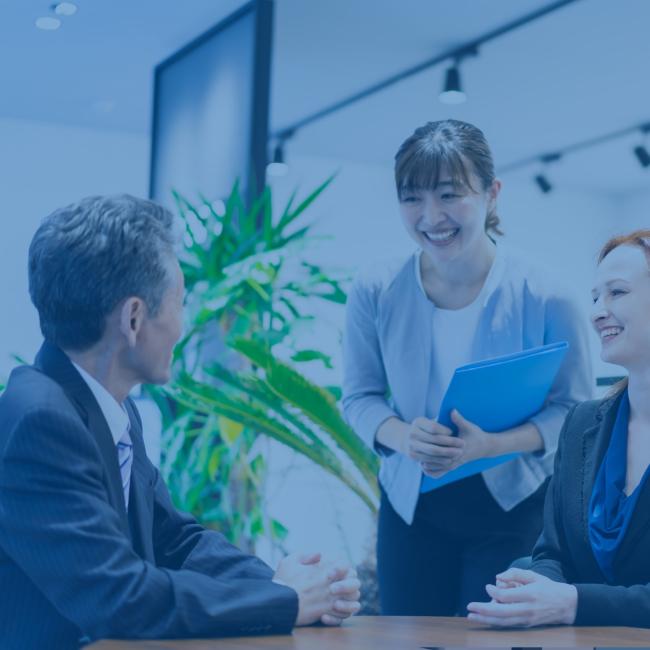 A business man consulting with his legal advisor through an interpreter.