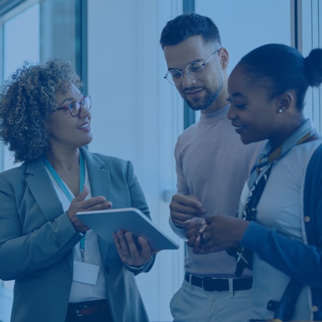 A couple consult a bank teller. 